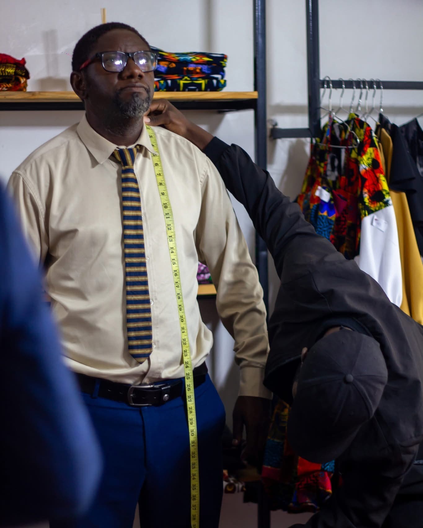 A Hartbrooks client being measured in the Lusaka atelier