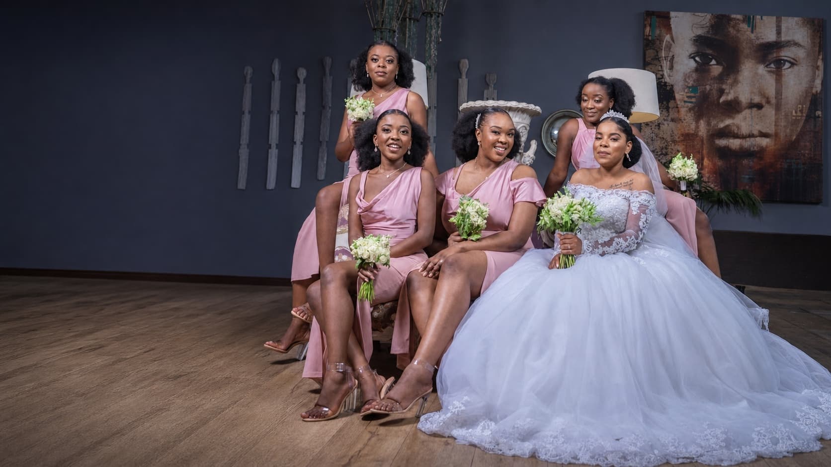 Bride and bridal party dressed for a celebration by Hartbrooks