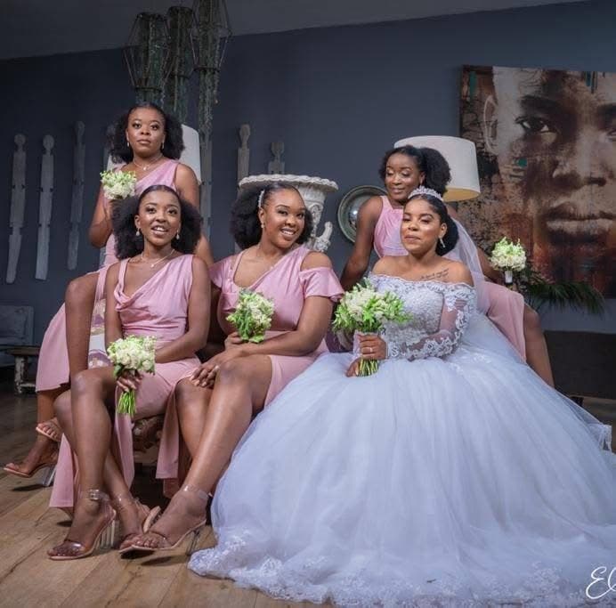 Bride and bridal party dressed for a celebration by Hartbrooks