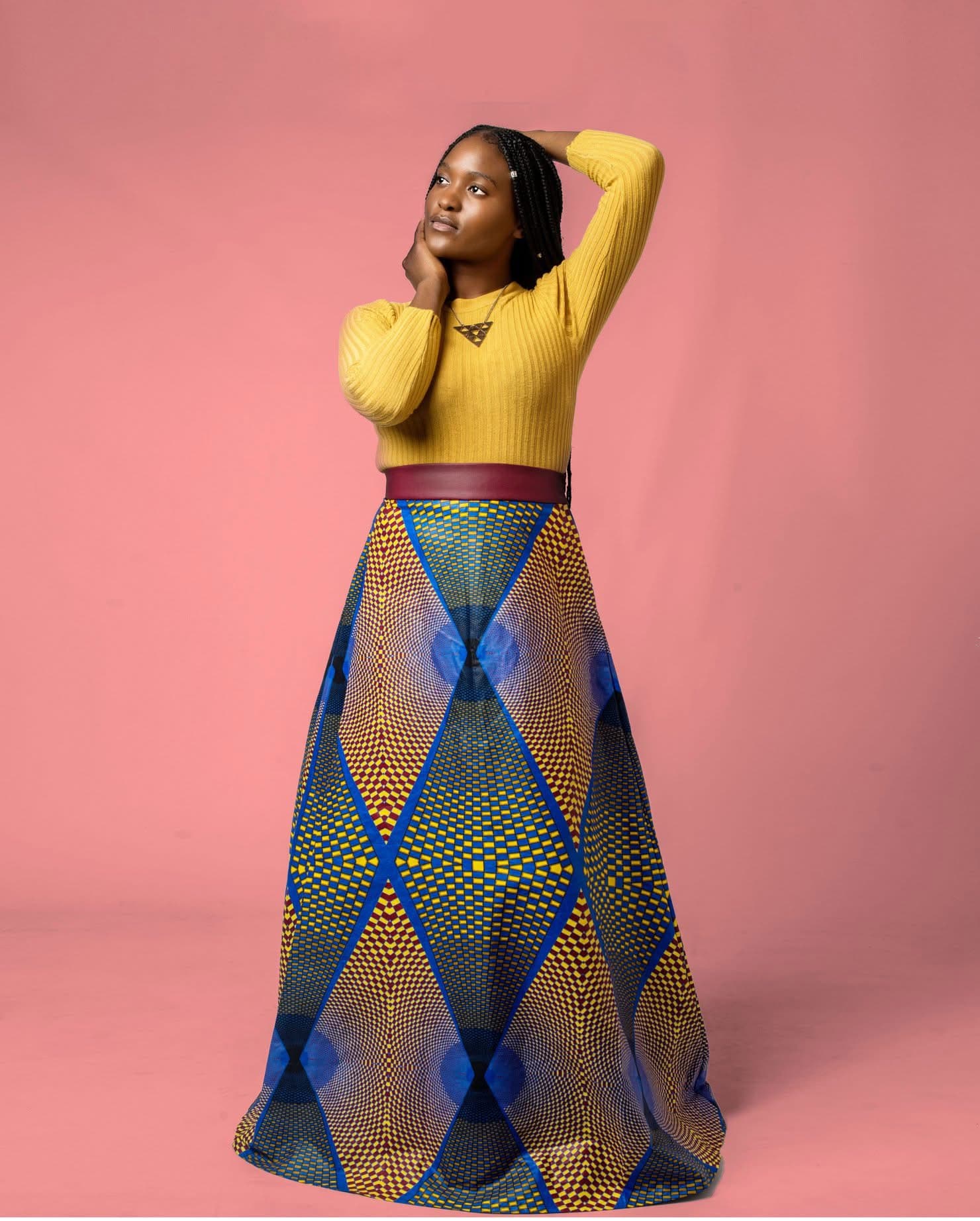 Model wearing a blue and yellow African print Hartbrooks statement skirt